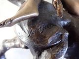 a bronze statue of a bull with a horn on it ' s head
