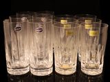 six glasses are lined up in a row on a black surface