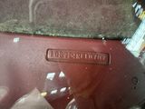 a close up of a red car door handle with a sticker on it