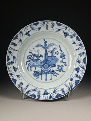 a blue and white plate with a picture of a man on a horse