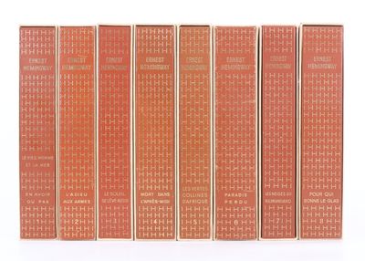 un lot de cinq livres posés sur une surface blanche