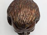 a small statue of a man with a hat on it ' s head