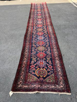 a long rug on the ground in a parking lot