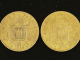 two gold sovereigns, one of which has a coat of arms and the other of which is a crown
