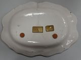 a white plate with two gold squares on it
