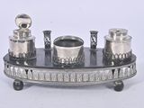 a silver plate with a set of silver objects on it