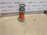a gas can and a pair of wooden sticks on the ground