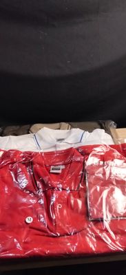 a red shirt on a table with other items on it