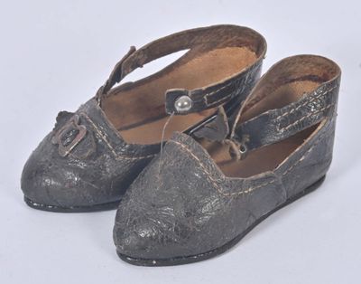 une vieille paire de chaussures posée sur une surface blanche
