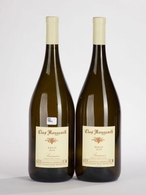 two bottles of wine sitting next to each other on a white surface