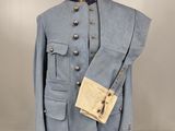 an old blue uniform on a mannequin stand with a bag