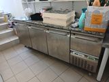 a kitchen with a stainless steel counter top and a refrigerator