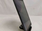 a tablet computer sitting on top of a stand on top of a table