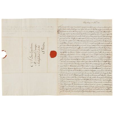 une lettre écrite en arabe sur un bout de papier à l'encre rouge