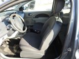the interior of a small car with a steering wheel and a dashboard