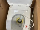 a toilet that is sitting in a box with the lid up