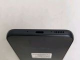 the back of a black cell phone sitting on top of a table