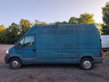 a blue van that is parked in a parking lot