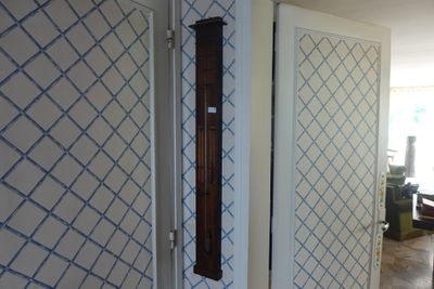 a clock on the wall in the hallway of a house