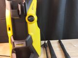 a close up of a yellow and black vacuum cleaner on a wooden table