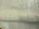 a close up of a white shirt with a monogram on it