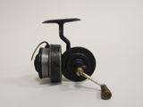 a close up of a fishing reel on a white surface