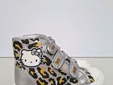 a close up of a pair of hello kitty shoes on a table