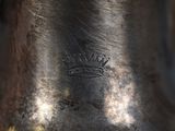 a silver vase that has a crown on it