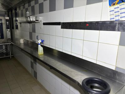 a kitchen with a sink and a stove in it