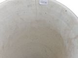 a white vase that has a sticker on the side of it