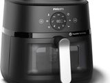 La friteuse à air chaud Philips est noire et dotée d'une poignée blanche.