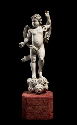 an image of a statue of a cupid holding a book