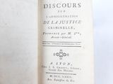 an old book that is open on a white surface