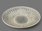 a clear glass bowl with a starburst design on it