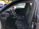 the interior of a car with the driver ' s seat folded down