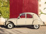 a small car that is parked in front of a red door