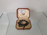 a glass display case with a ring inside of it