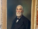 painting of a man in a suit holding a picture of himself