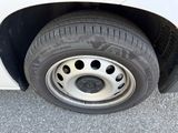 a close up of a tire on the side of a white car