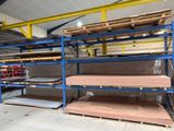 shelves in a warehouse with a lot of wood on top of them