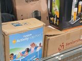 a shopping cart filled with boxes and other items in a store