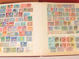 an open book with stamps on it sitting on a table
