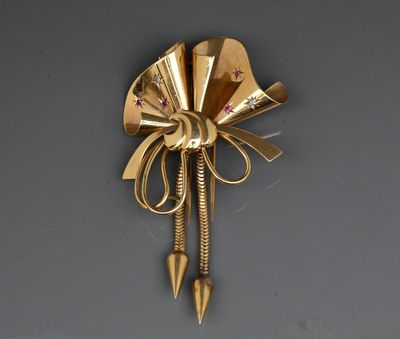 a gold brooch with a bow on the back of it