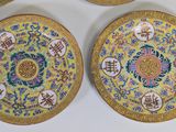 three plates with chinese writing on them are sitting on a table