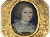 portrait d'un jeune homme dans un cadre doré, portant un col blanc