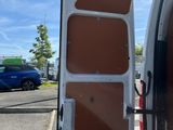 a white van with its door open on the side of the road