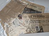 a pile of newspapers sitting on top of a table