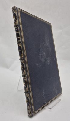 an old book sitting on top of a white surface