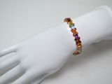 bracelet with multicolored stones on a mannequin hand