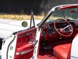 a red and white car with its door open